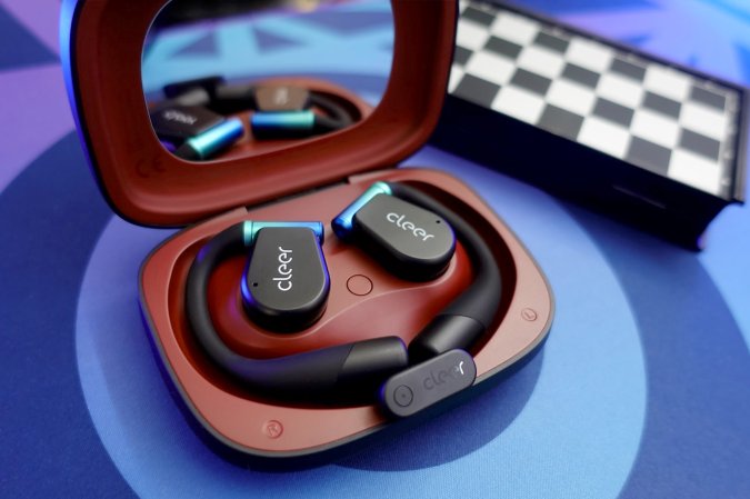  Cleer ARC 3 open-ear gaming earbuds in a red case on a blue table