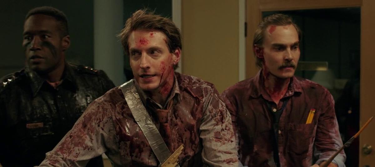 Three men covered in blood