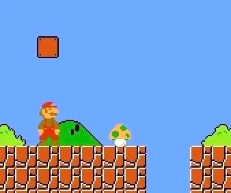 Ο Super Mario αποκαλύπτει το πρώτο μανιτάρι 1-Up μέσα σε ένα κρυφό μπλοκ ακριβώς πριν από το πρώτο pit στο World 1-1 στο Super Mario Bros. Στιγμιότυπο οθόνης: supermarioplay.com.