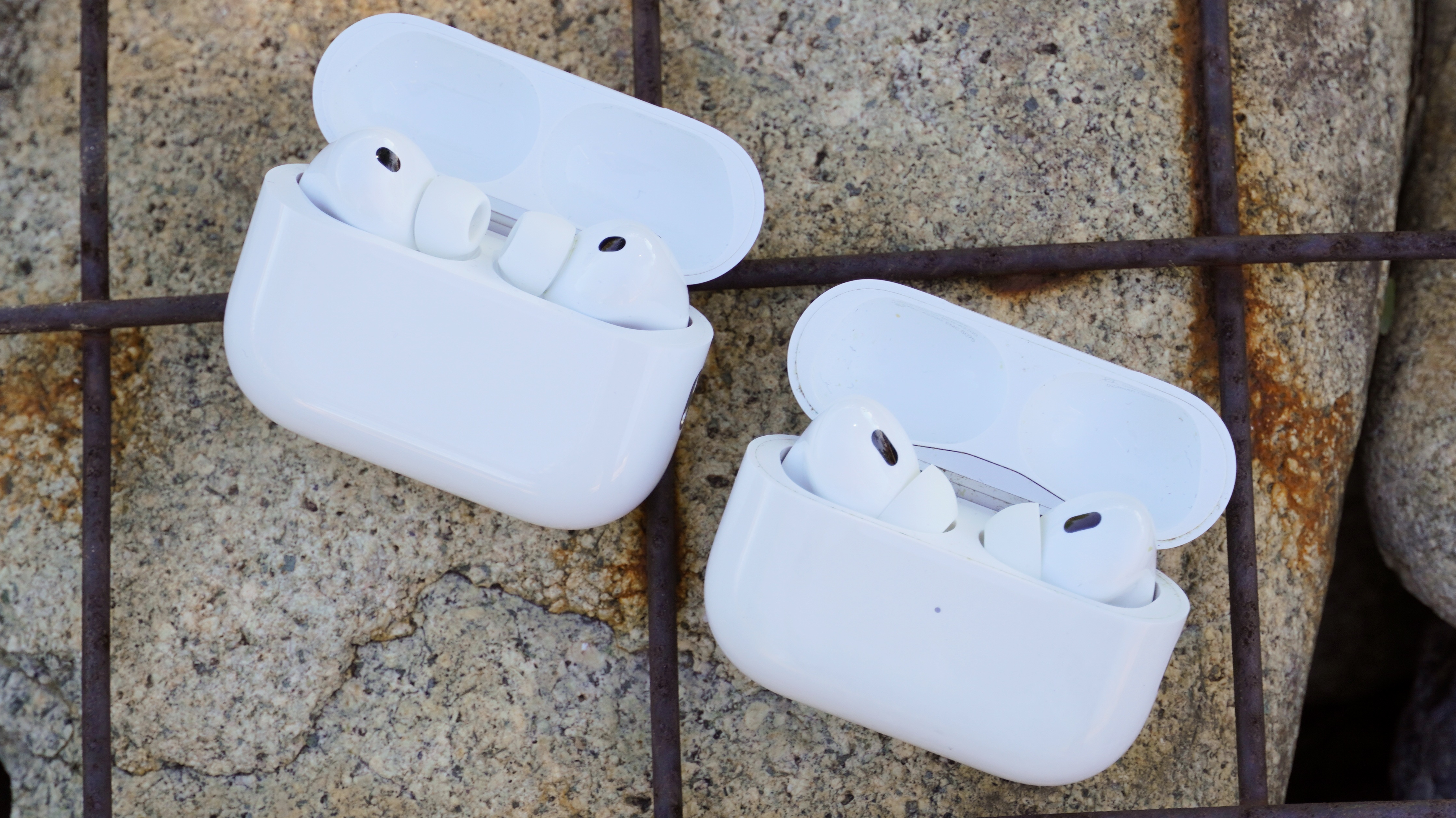 The AirPods Pro 3 with their charging case at a park.