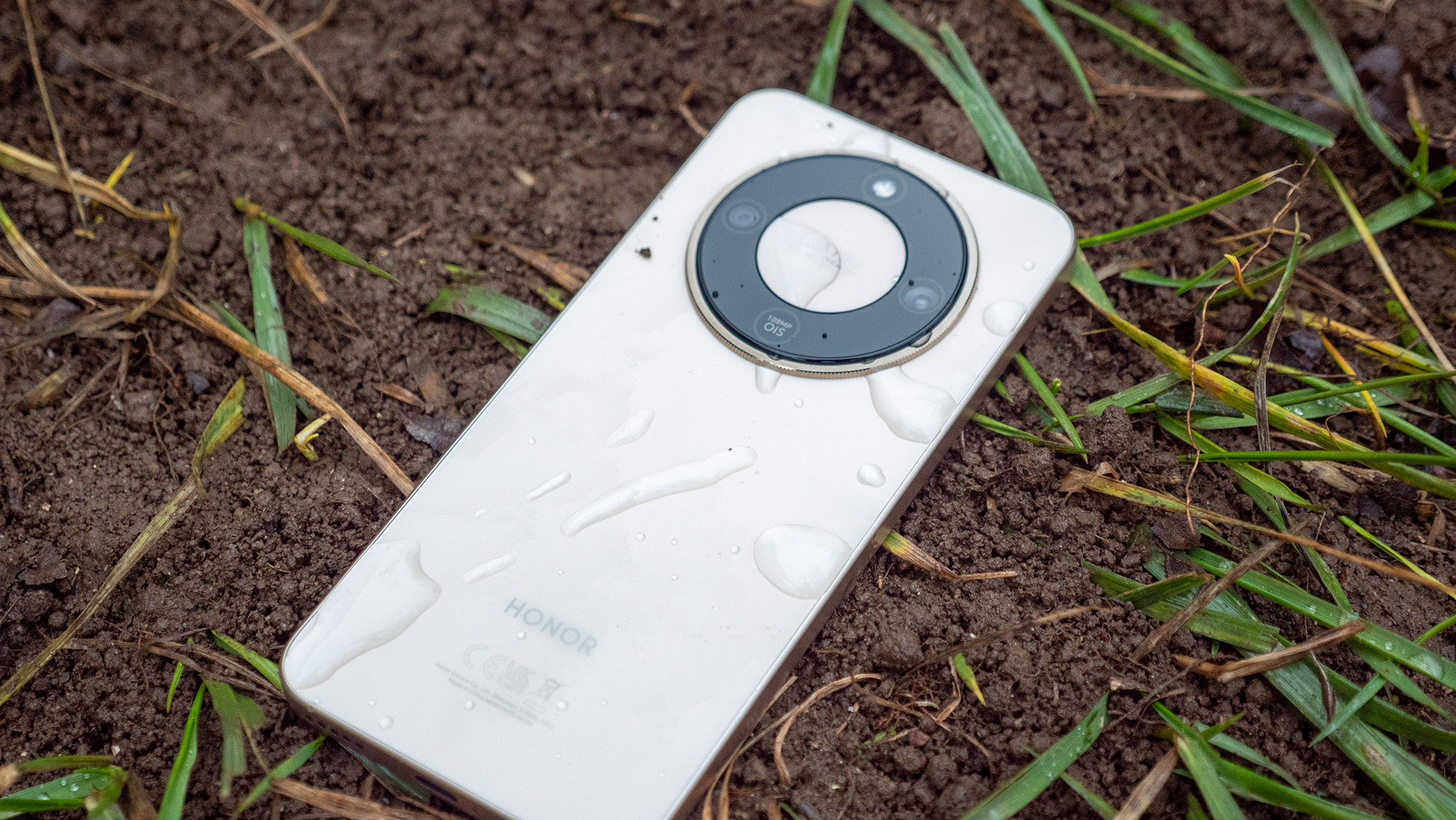 The Honor Magic 8 Lite with water on its back