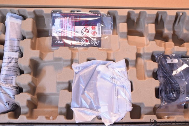 An unboxed MSI 'Curved Gaming' monitor packaging with wrapped components and cables inside a cardboard tray.