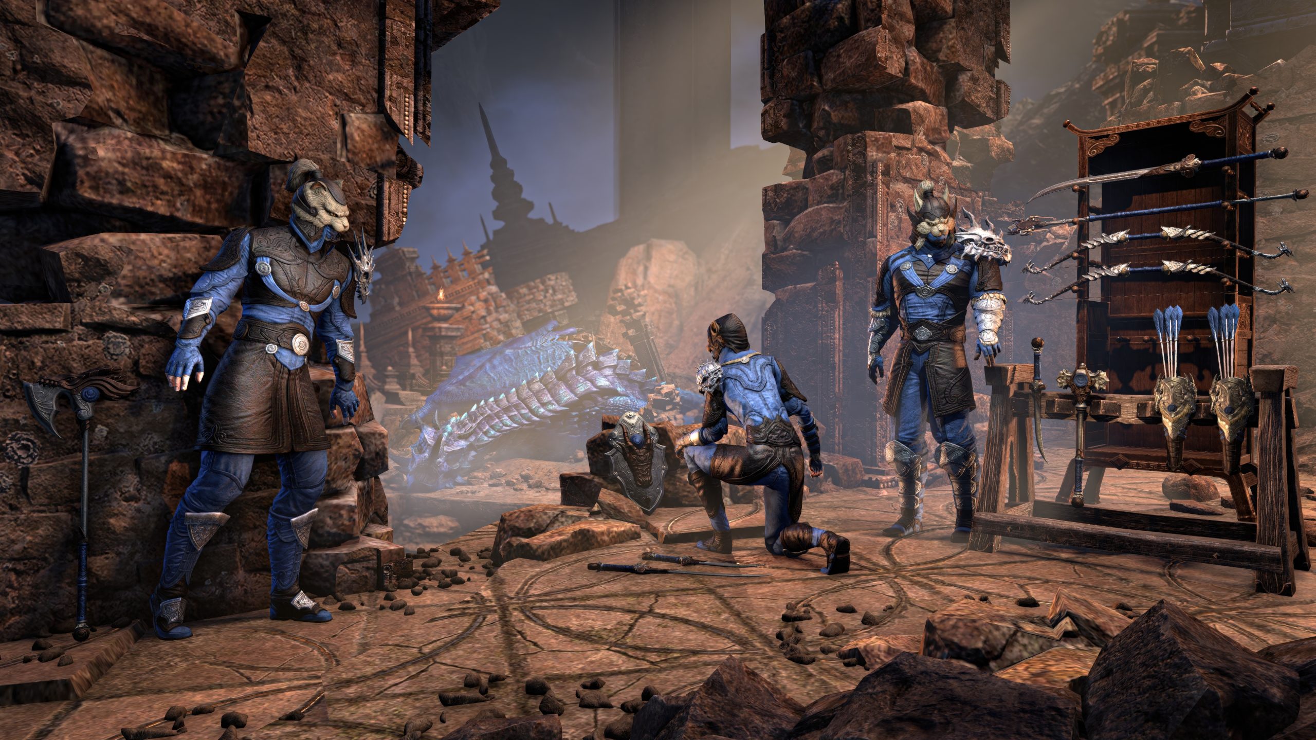 Three armoured characters from The Elder Scrolls Online stand in a stone ruin with a defeated dragon in the background and various weapons displayed on a rack.