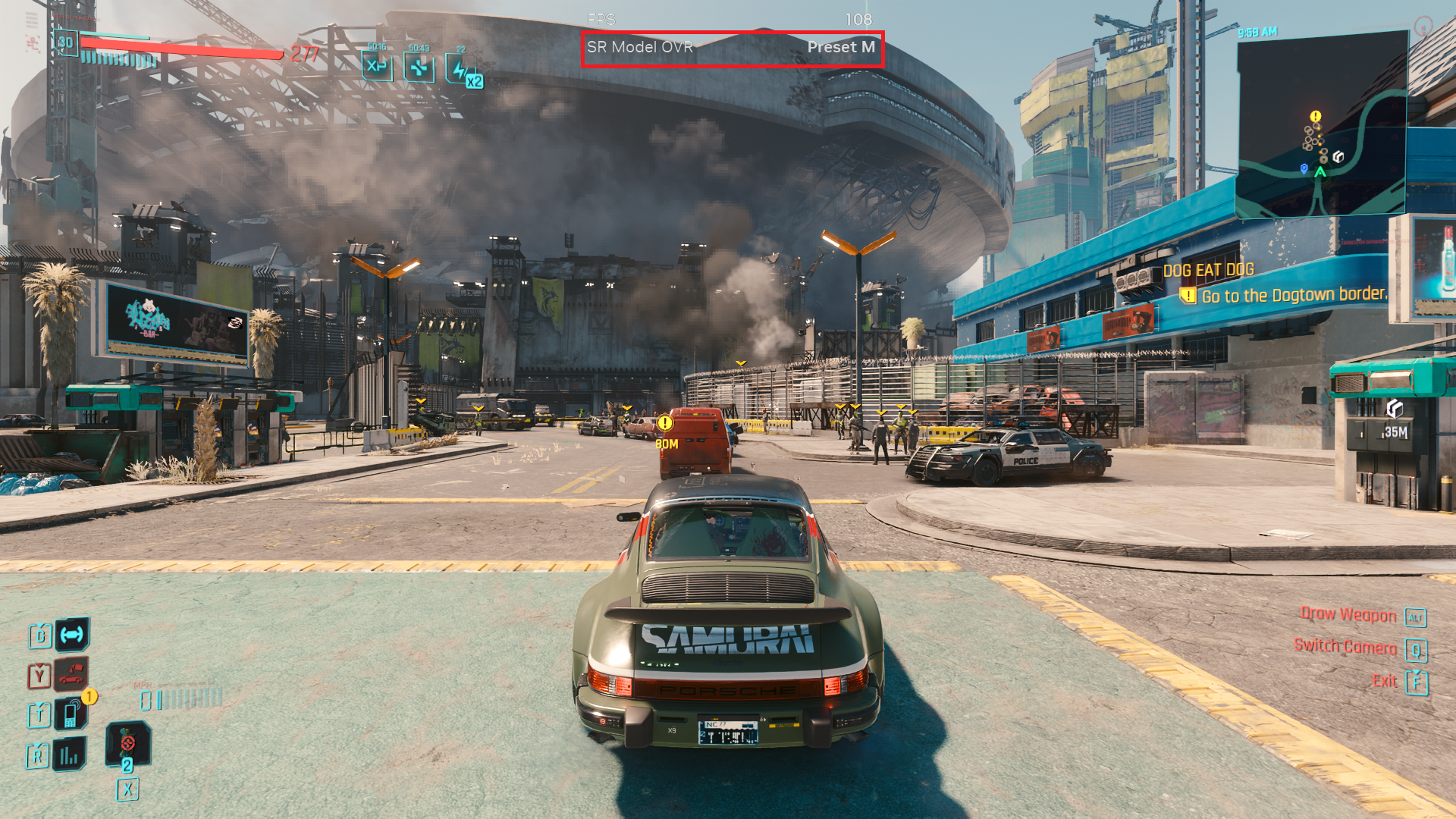 A player drives a 'SAMURAI' branded Porsche with in-game text 'Go to the Dogtown border' in 'Cyberpunk 2077.'
