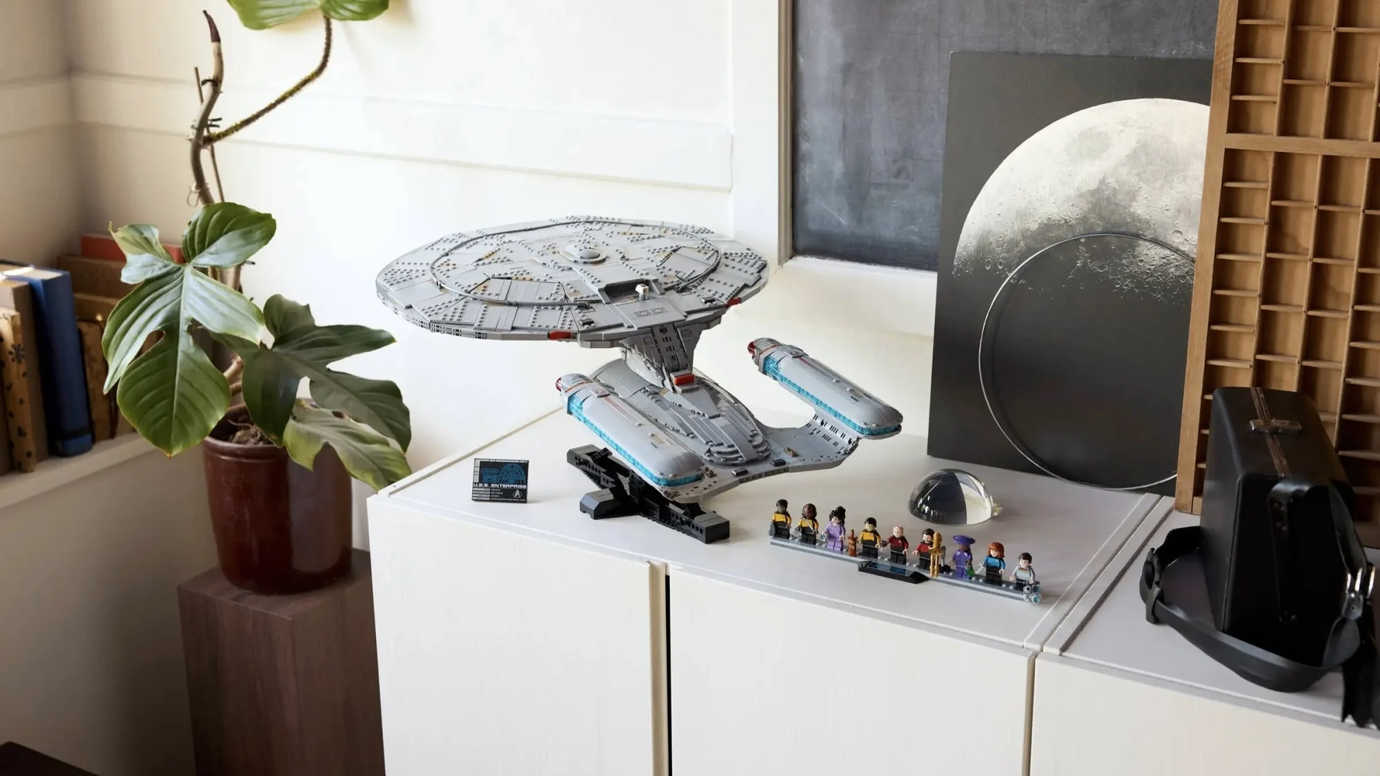 Lego Icons Star Trek: U.S.S. Enterprise with minifigs on sideboard in room