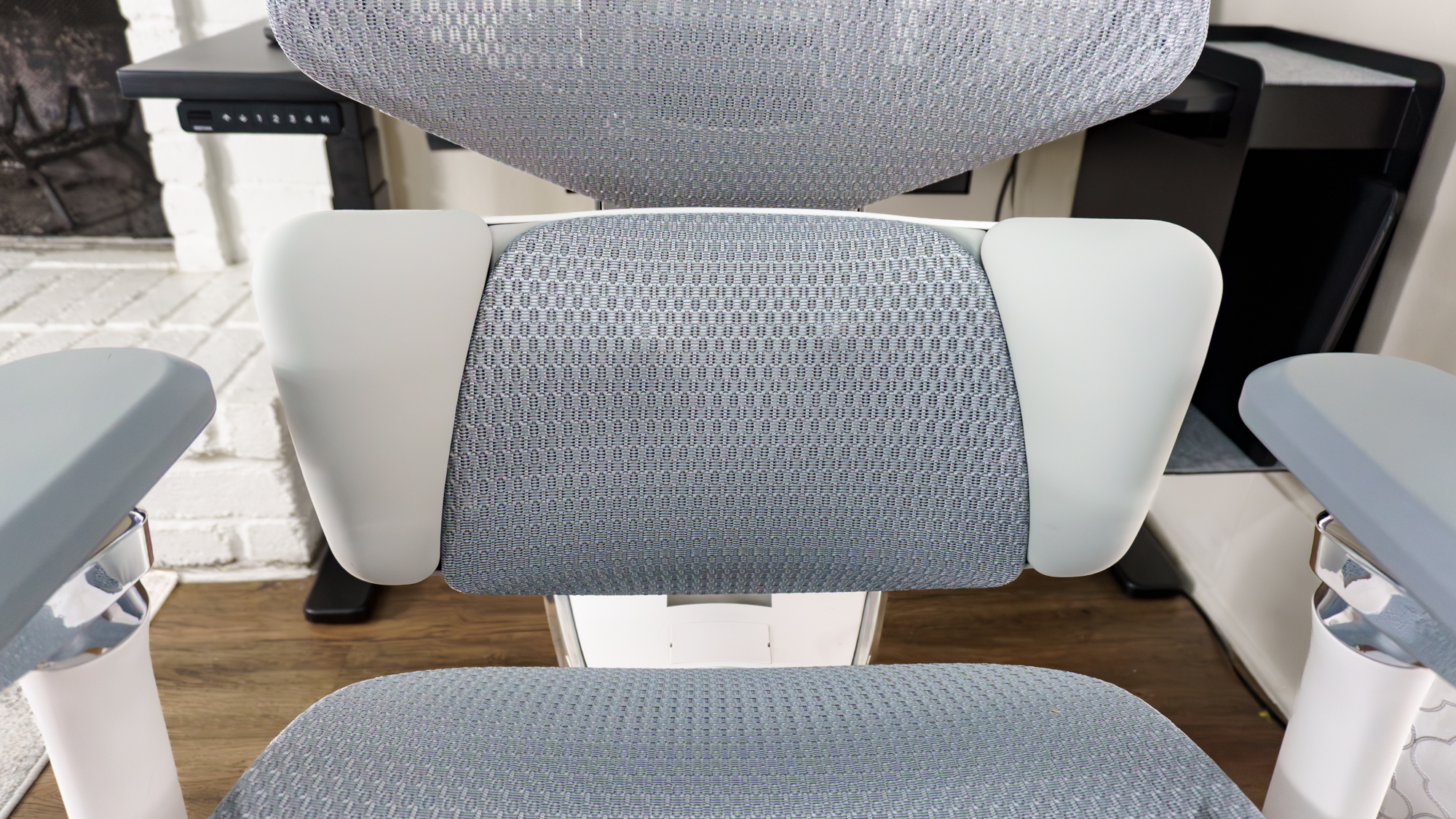 A close-up shot of the Hbada X7 office chair's lumbar support showing the roller heads of its built-in massager