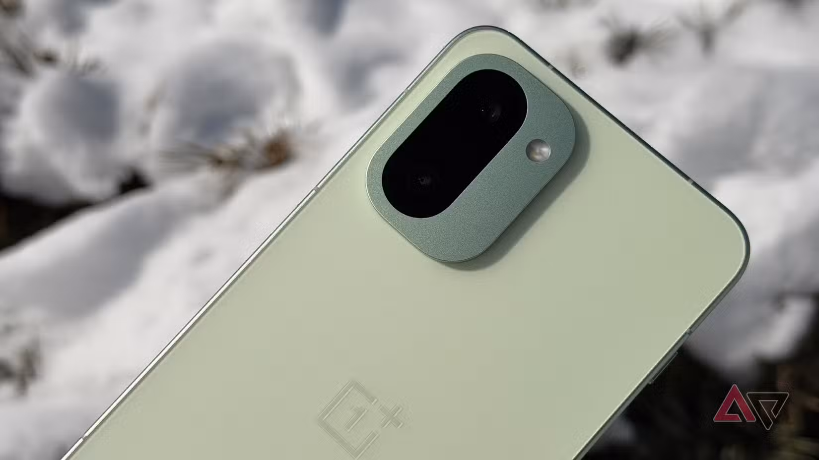 OnePlus 15R in Mint Breeze with a snowy background