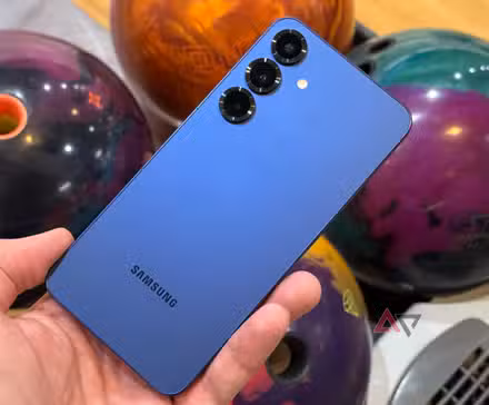 Samsung Galaxy S25+ held up against bowling balls