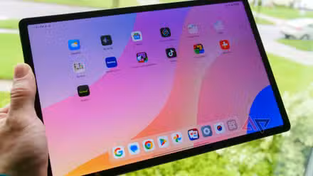 The Lenovo Idea Tab Pro in a hand with the screen on.