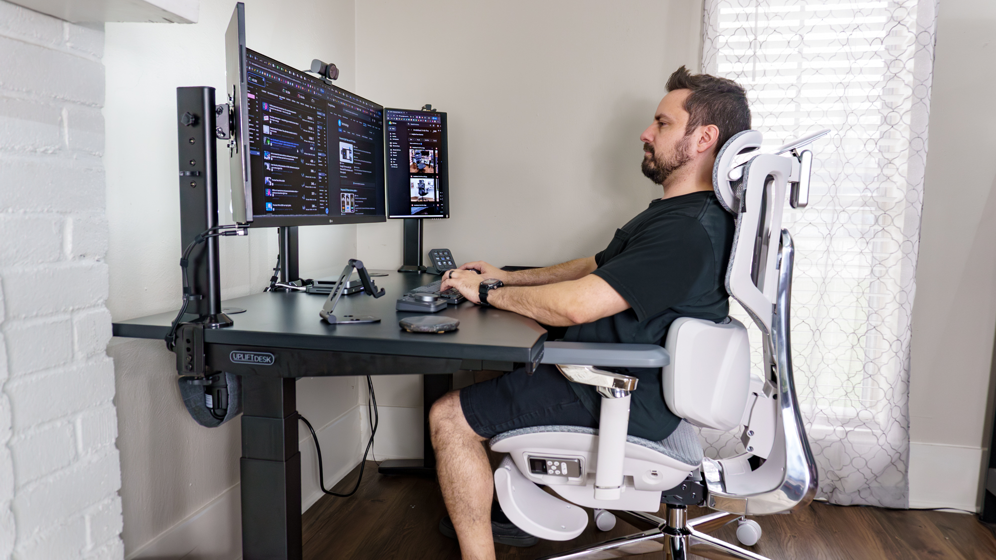 A person sitting in the Hbada X7 office chair at their desk