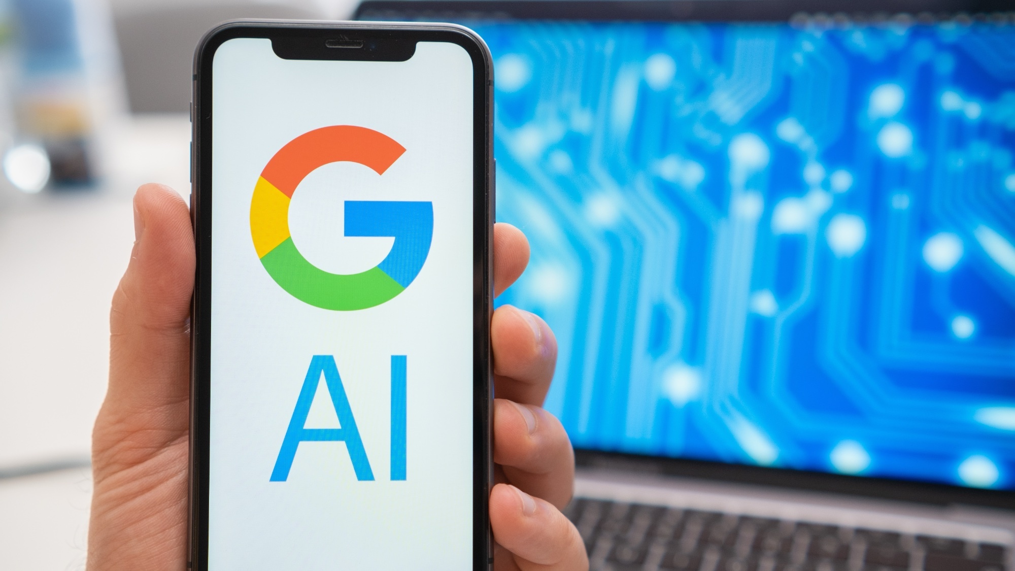 Google AI στο τηλέφωνο με φορητό υπολογιστή στο φόντο