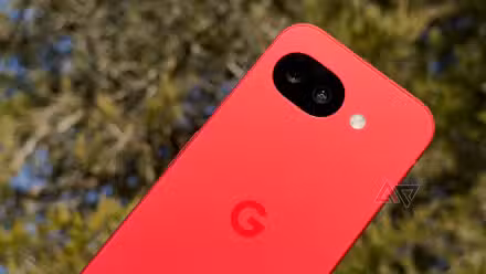 Google Pixel 10a held up against a green tree