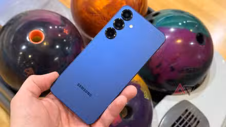 Samsung Galaxy S25+ held up against bowling balls